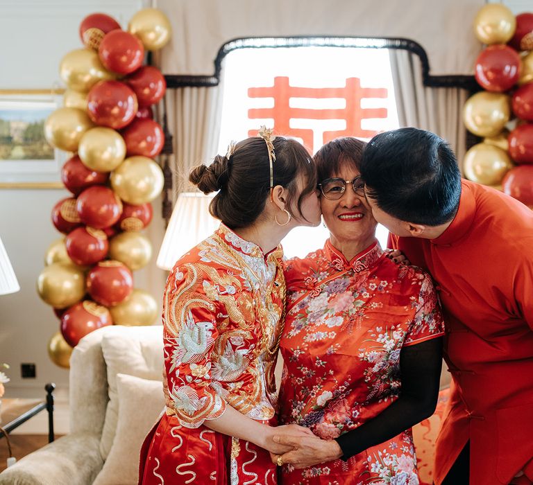 Bride & groom kiss family member at Chinese Tea Ceremony 