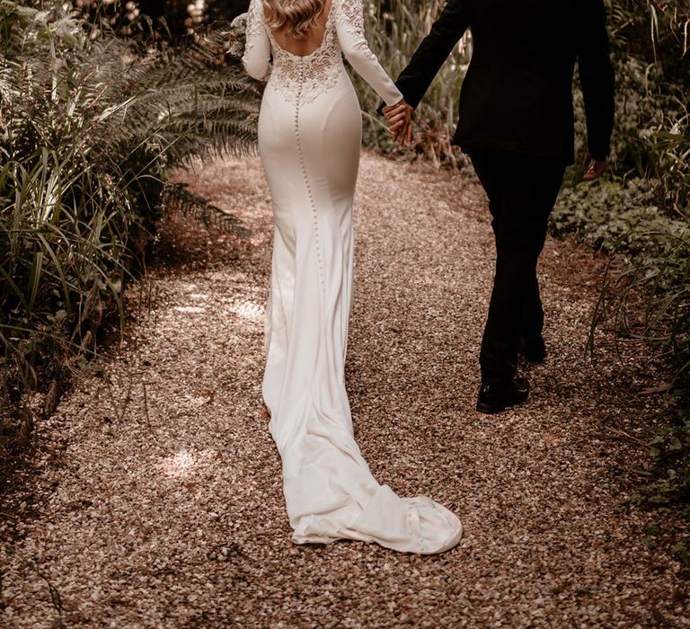 Bride in a low back beaded wedding dress from Badgley Mischka with the groom in black tie for Pennard House wedding 