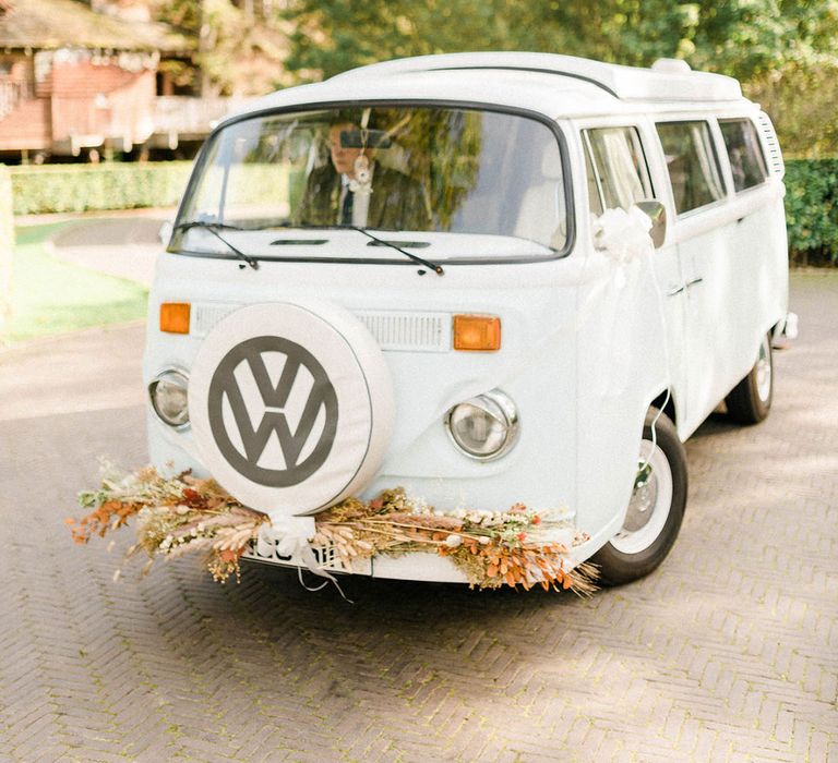 White VW camper van wedding transport complete with dried floral decor to the front 