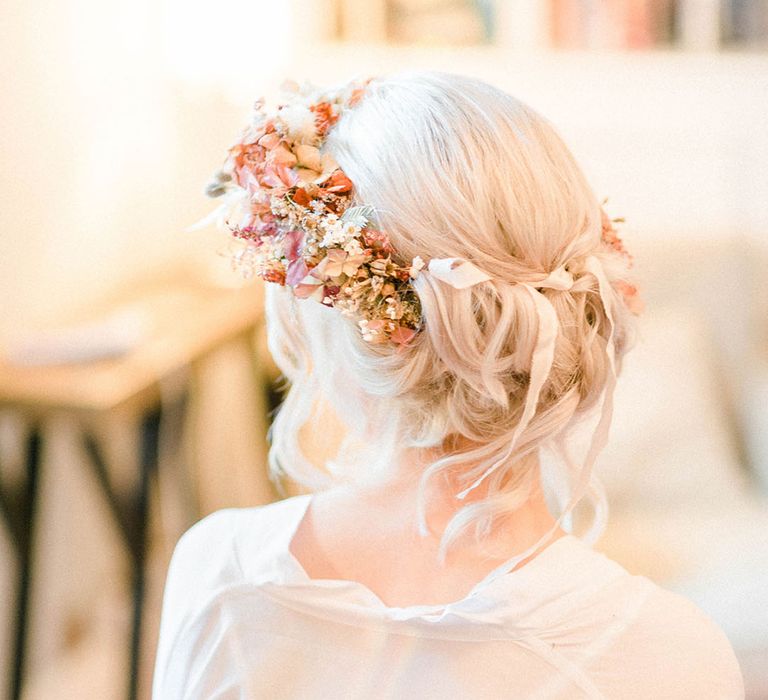 Bride wears dried flower crown in her blonde hair complete with silk ribbon 