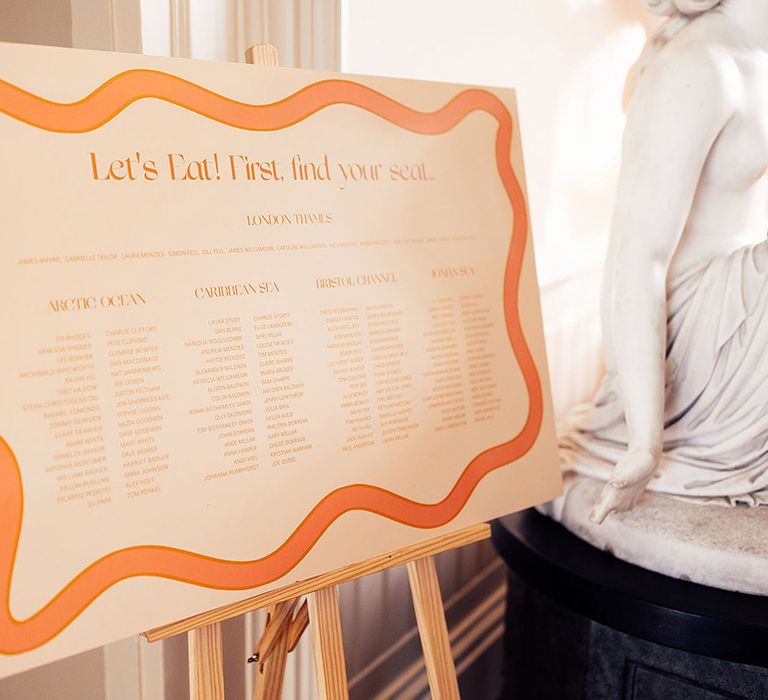 Orange wedding seating chart and table plan sign for autumn wedding 