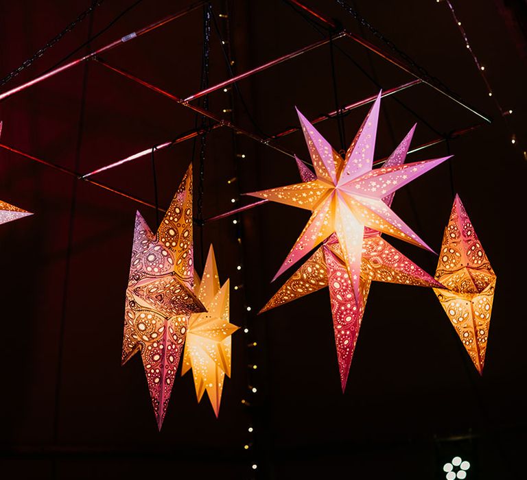 Intricate star lanterns decorating the wedding tipi 