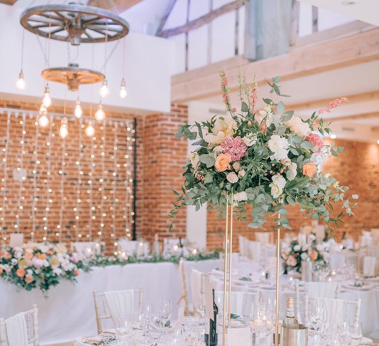 Reymerston Hall wedding breakfast decoration with tall table centrepieces and seasonal floral arrangements 