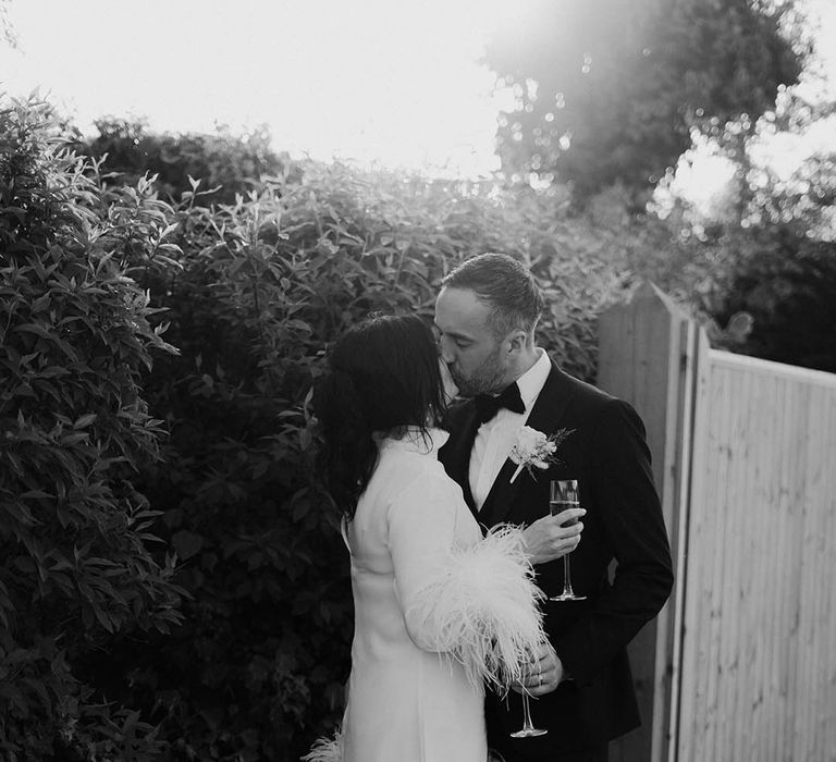 Bride wearing Jimmy Choo white wedding shoes with feather wedding dress 