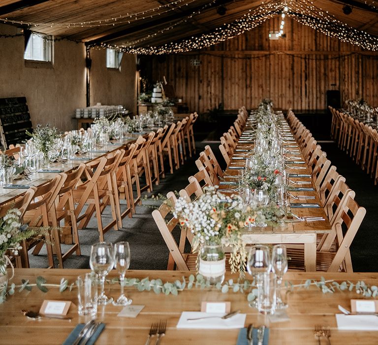 Stanford farm wedding reception with fairy lights and foliage decoration