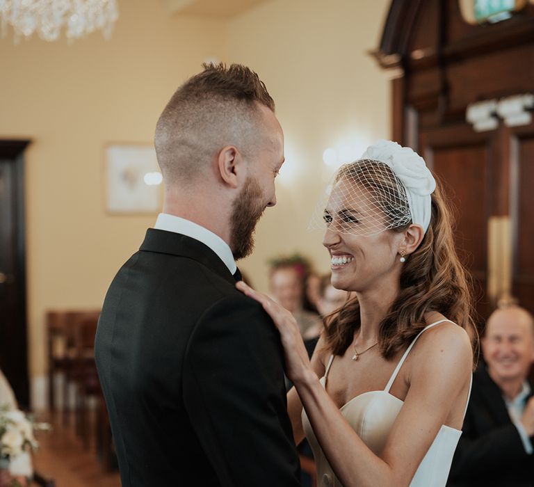 bride in a headband with birdcage blush veil bridal accessory at town hall wedding 