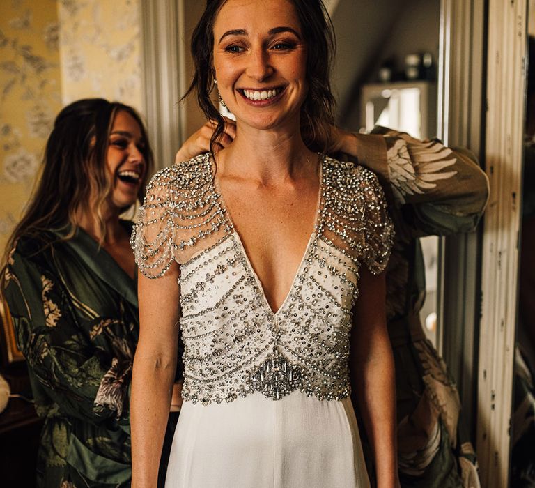 Bride in sparkly beaded wedding dress with short sleeves by Jenny Packham 