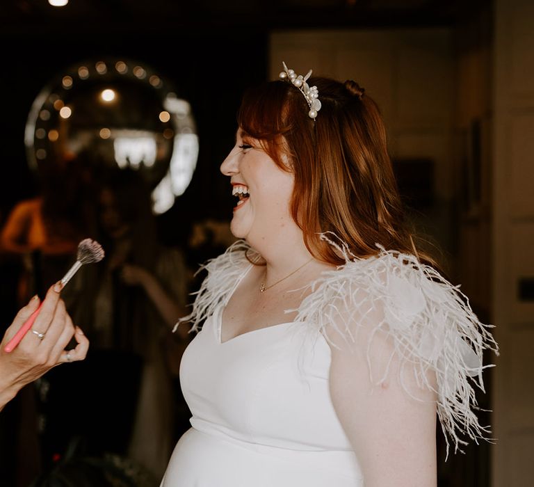 Bride wearing feather sleeve wedding dress and flower enamel headband 