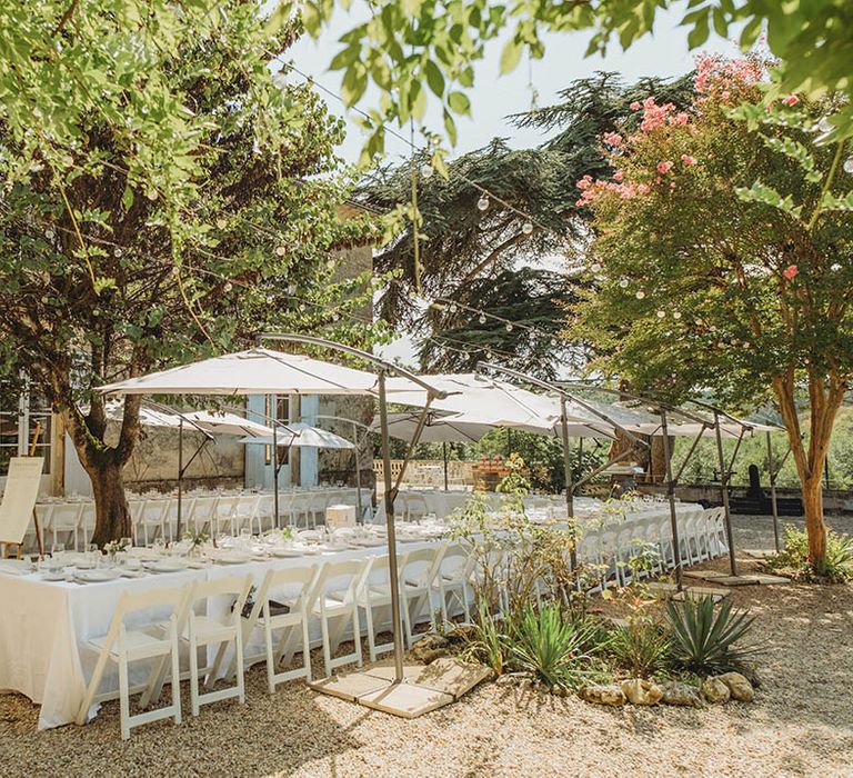 Outdoor destination wedding breakfast in France with white tablescapes 