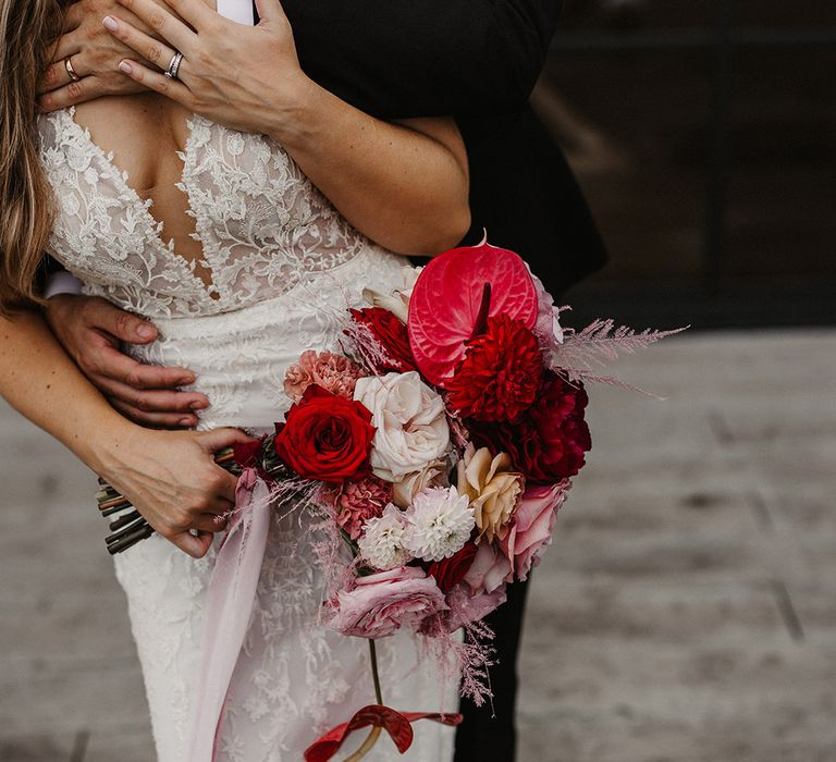 Red and pink wedding bouquet with roses and anthuriums 