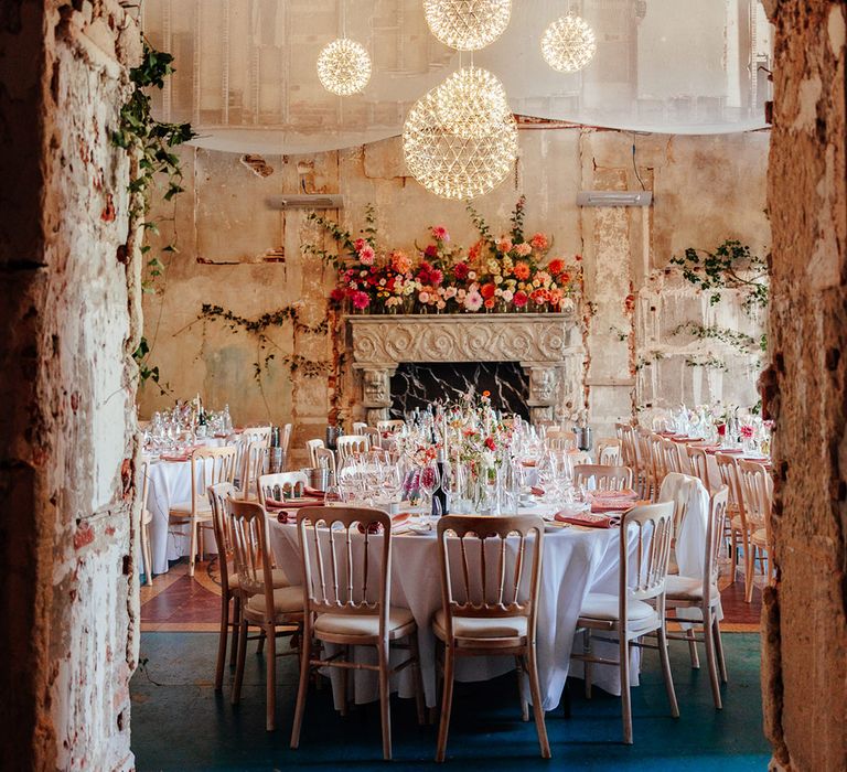 Pink wedding tablescapes at The Grange Hampshire with delicate light fixtures 