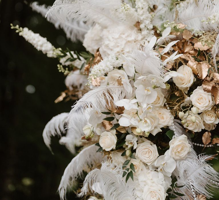 All white wedding flowers for altar decorations with pampas grass, roses and orchids 