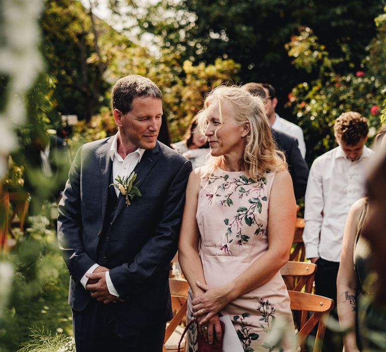 Mother and father of the bride at outdoor wedding ceremony 