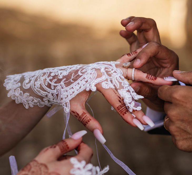 Groom putting on his brides wedding ring 