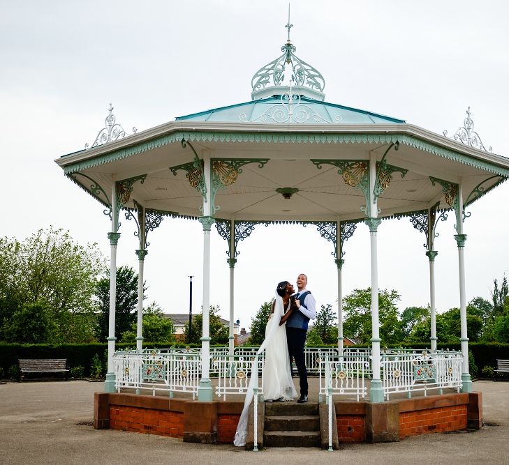 Bride and groom portrait on the bandstand in Liverpool 