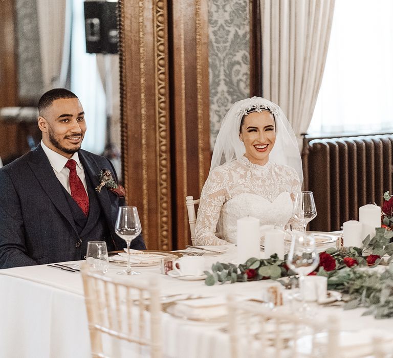 Bride and groom smiling at intimate wedding reception 