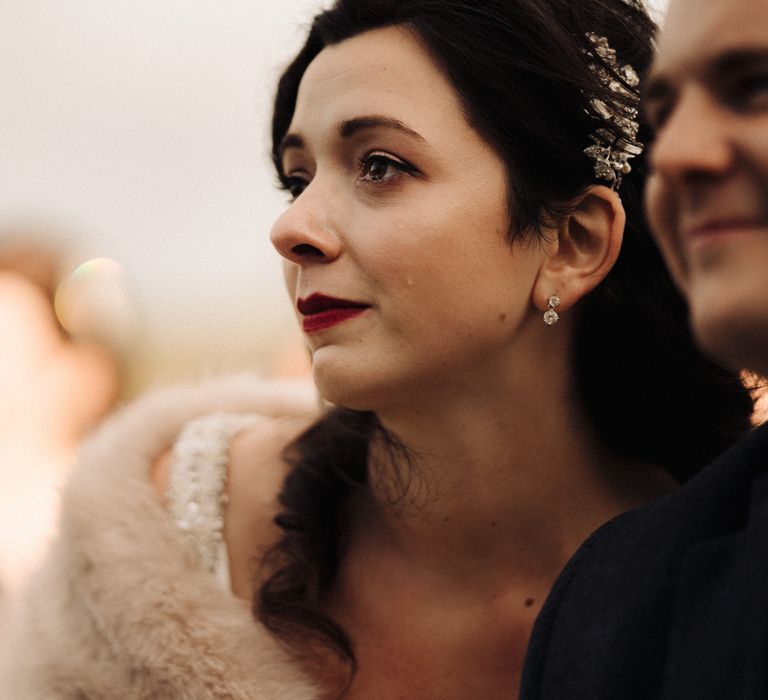 Emotional bride with red lipstick and fur stole 