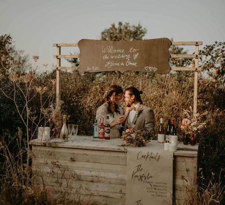 Outdoor wooden cocktail bar at a sustainable wedding