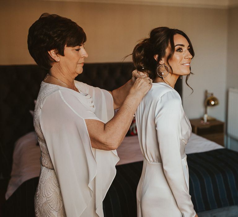 Brown haired bride gets ready on wedding morning