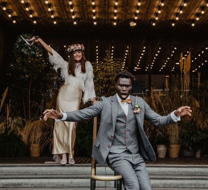 Groom slides down railings outside of Shoreditch cinema