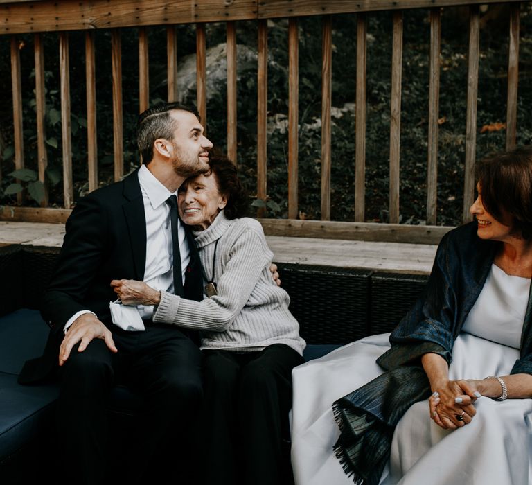 Groom hugs wedding guest on the day of wedding