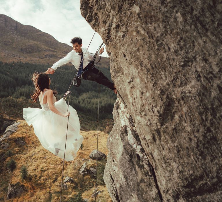 Couple rock climbing in Scotland countryside