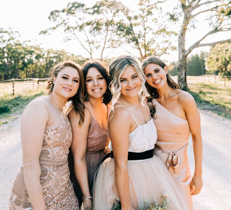 Bride with bridesmaids in blush dresses