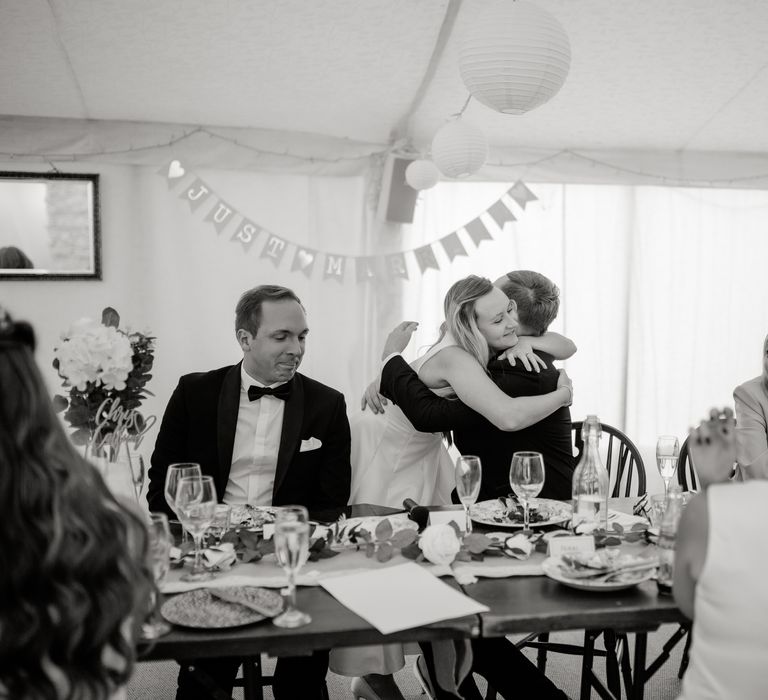 Black & white image of wedding party during reception