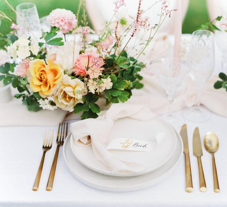 Minimal white tableware and gold cutlery for an English garden party wedding