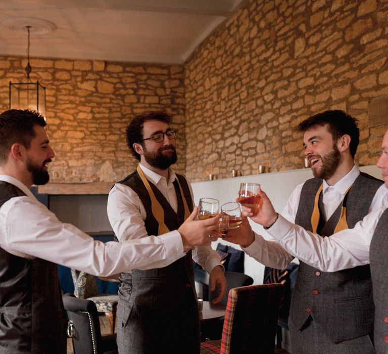 Groomsmen saying cheers on the morning of the wedding 