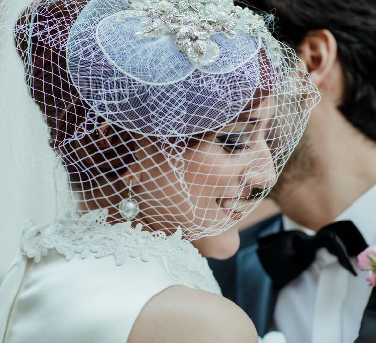 Vintage bridal fascinator with net veil and beaded detail for a 1960s themed wedding