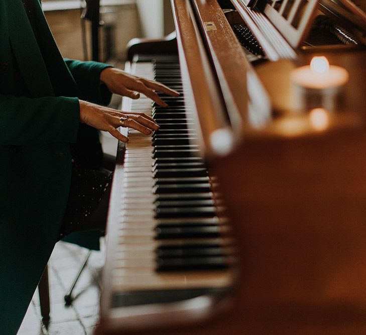 A pianist plays at a wedding. The image is a close ip of her hands playing.