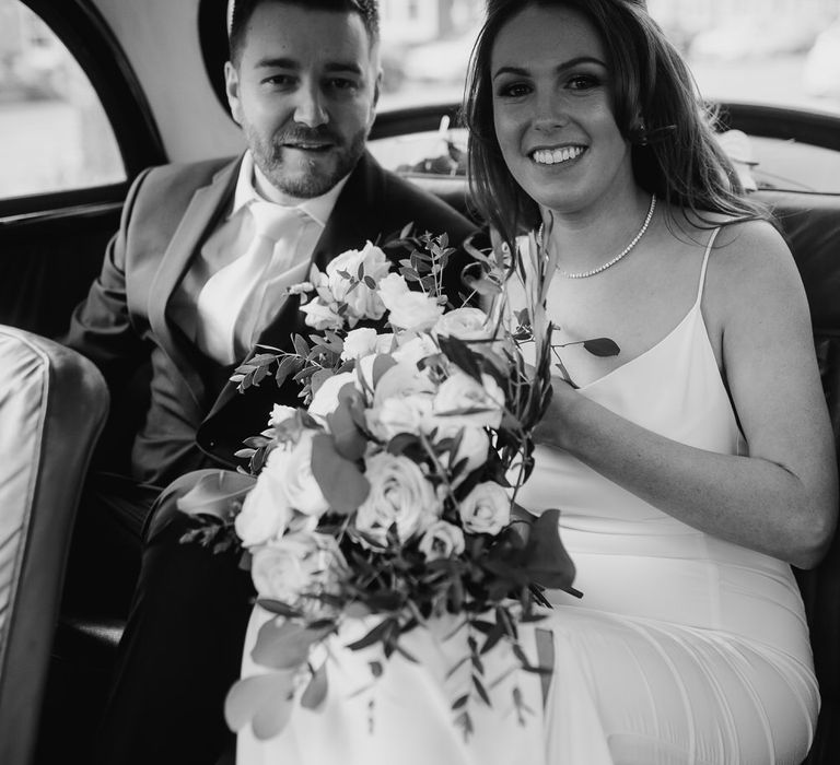 Bride and groom in their Morris Minor wedding car