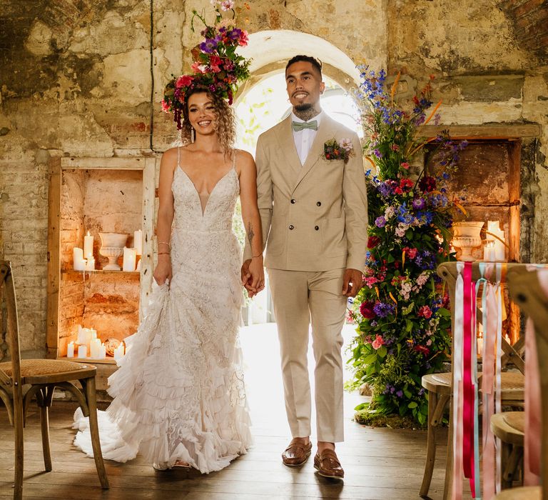 Colourful fiesta theme wedding with brightly coloured floral arrangement and flower crown and bride in an embellished wedding dress 