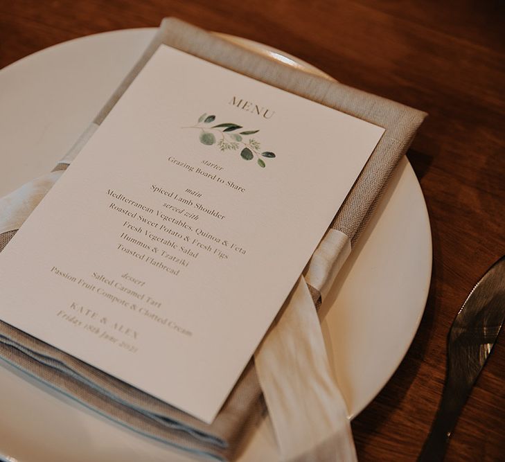 Place setting with linen napkin and menu card 