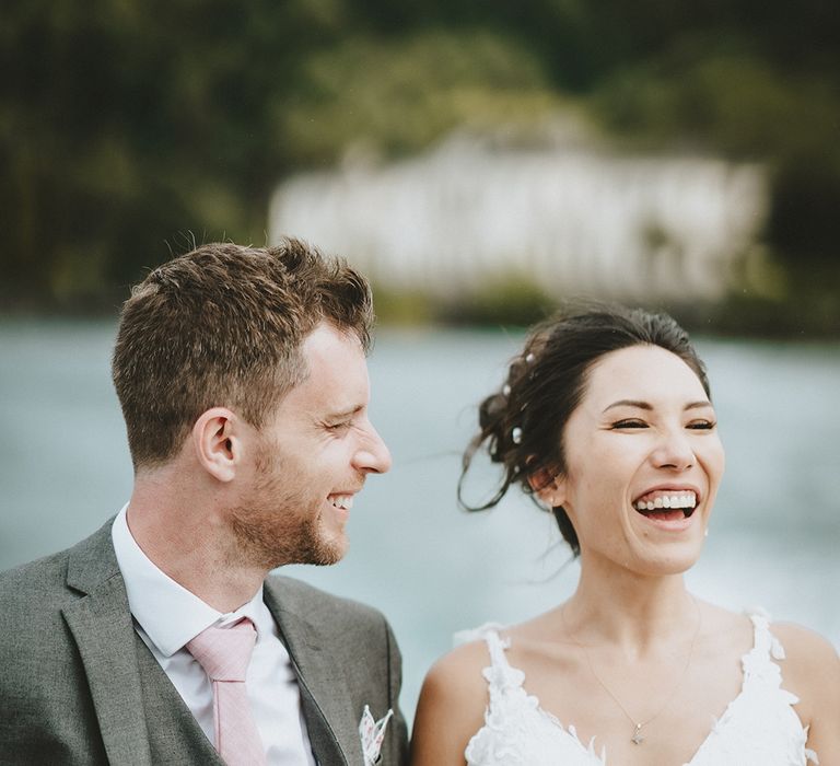 Bride & groom ride boat through Lake Como on their wedding day