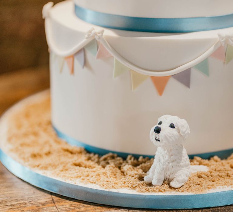 Wedding cake featuring fondant dog on sand