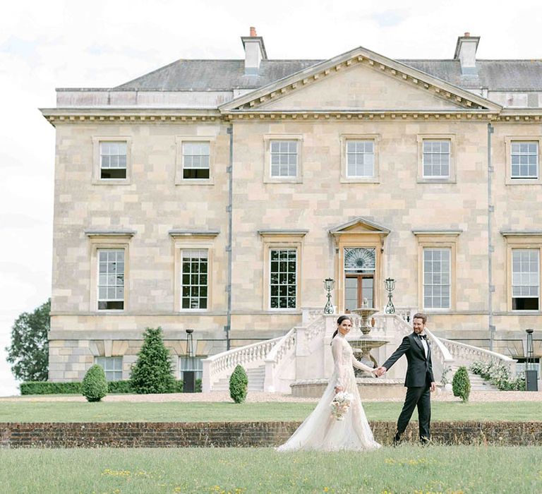 Elegant wedding at Botley's Mansion in Surrey with groom in a tuxedo and bride in a long sleeve wedding dress