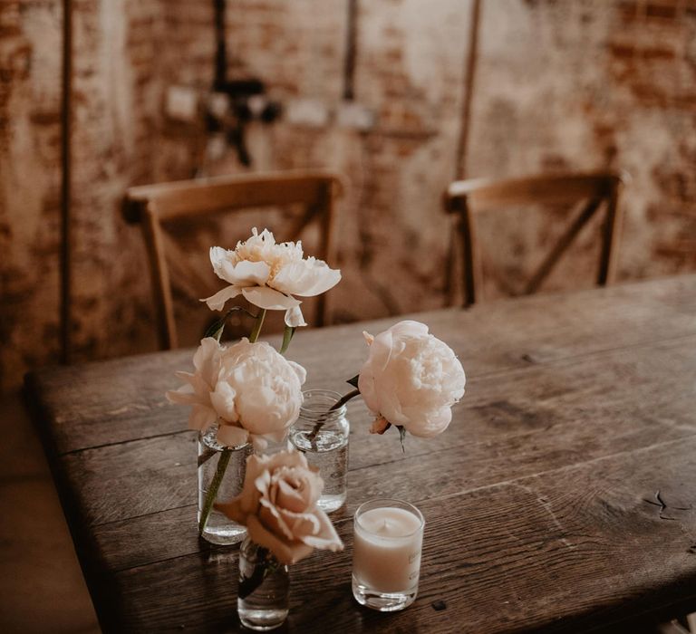 Neon wedding sign in front of wooden table complete with florals