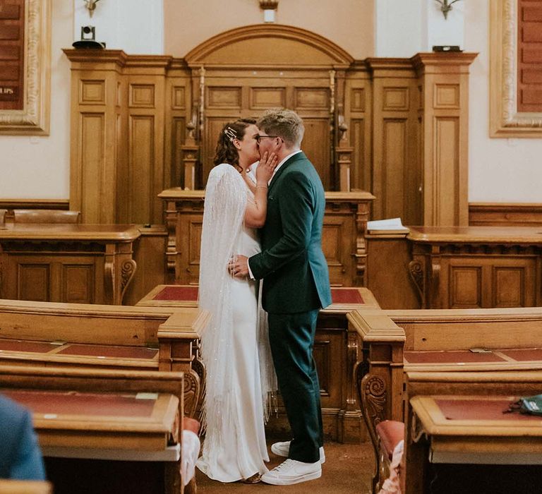 Bride & groom kiss at altar on their wedding day