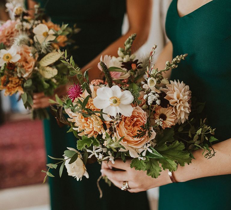 Colourful floral bouquet held by bridesmaids on wedding day