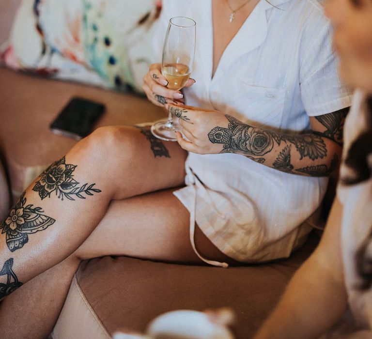 Bride sips champagne during preparations