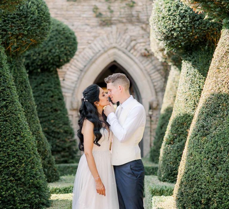 Bride & groom kiss outdoors on their wedding day