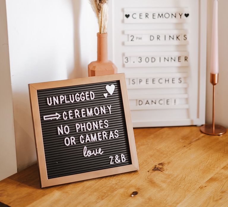 Unplugged wedding ceremony sign with order of the day sign and dried grass in copper vase for decor