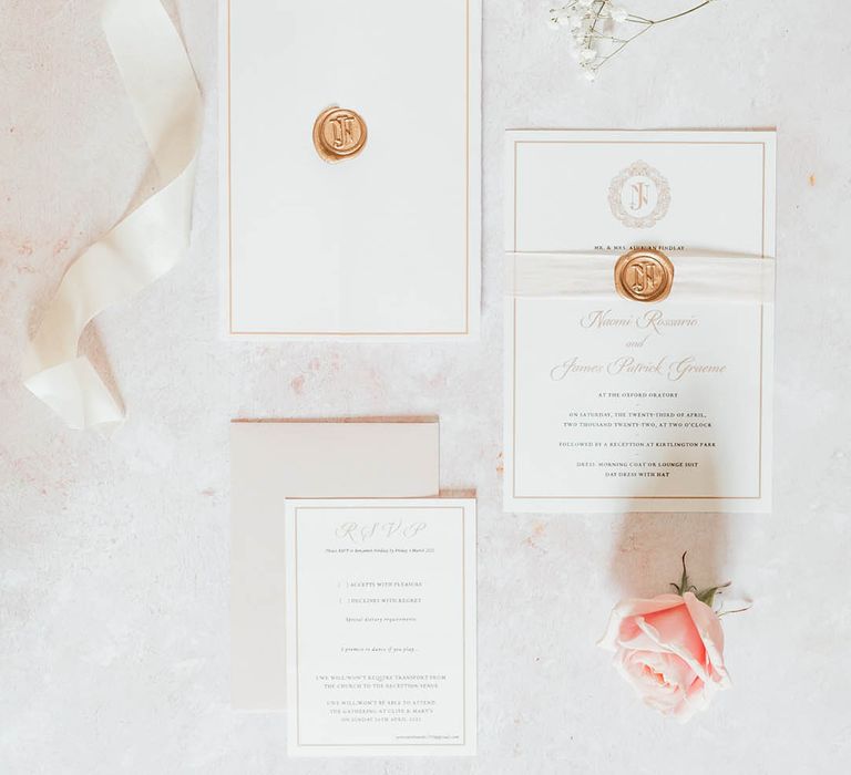 Classic white and gold wedding stationery with pink rose and white ribbons and gold wax seal 