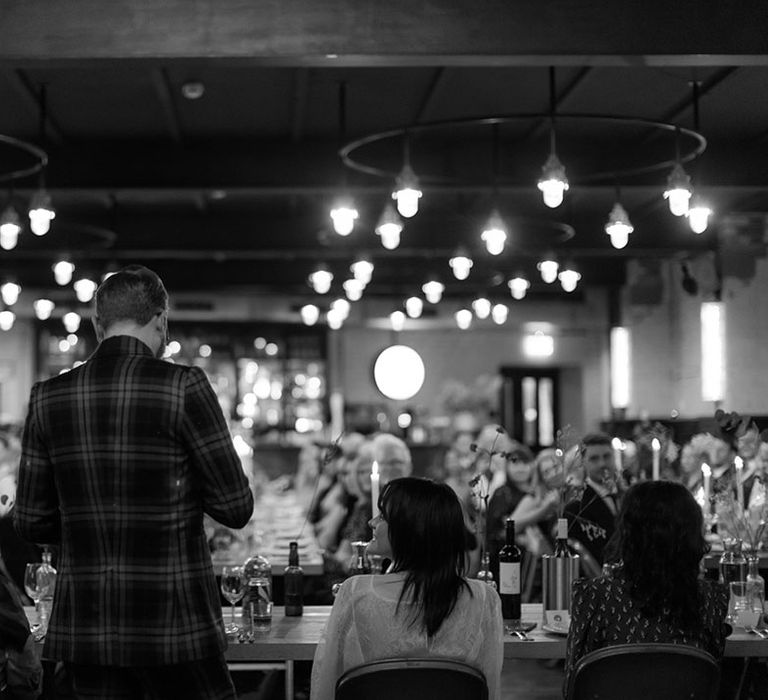 Groom reads speech during reception in black and white image at The Mowbray 