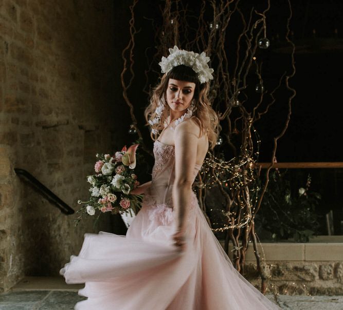 bride in a pink strapless wedding dress with corset bodice and tulle skirt twirling in Tithe Barn Hooton Pagnell