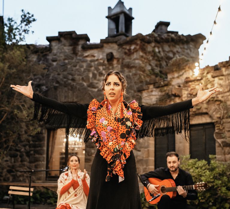 Traditional flamenco dancer at La Baronia performing outdoors complete with singer and Spanish guitarist 