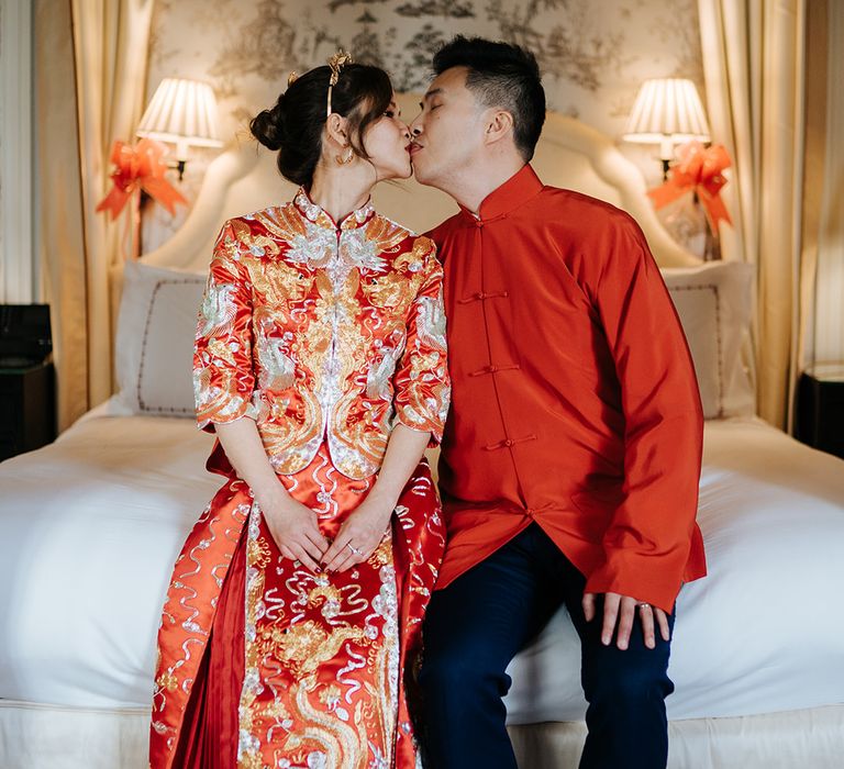 Bride & groom sit on bed at The Suite at The Dorchester after Chinese Tea Ceremony