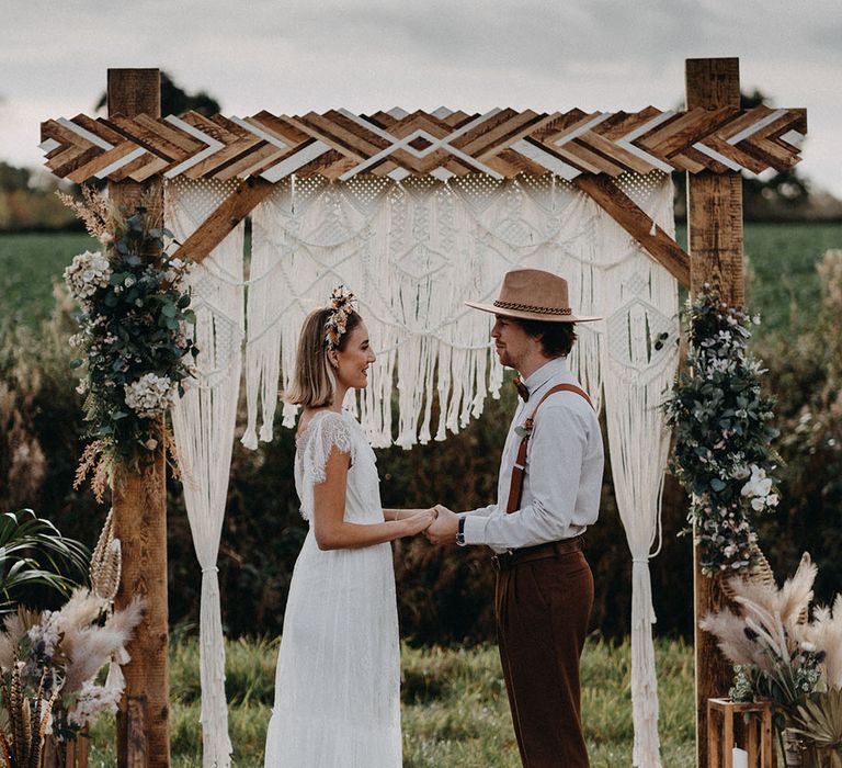 Outdoor wedding ceremony area with macrame decor and boho styling 